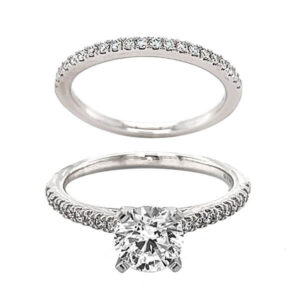 white gold engagement ring set with .20ct tw of French prong set brilliant cut diamond melee and a matching white gold wedding band set with .19ct tw of French prong set diamond melee 