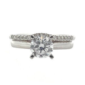 White gold solitaire engagement ring with a matching white gold diamond wedding band .12ct tw of prong set brilliant cut diamond melee