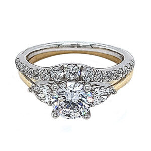 Two tone yellow and white gold 3 stone ring set with .32ct tw of pear shape diamond melee and a matching brilliant cut diamond contour band .35ct t.w. 