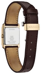 Gold tone stainless steel with green dial and leather strap.