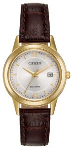 Gold tone stainless steel with silver dial and leather strap.