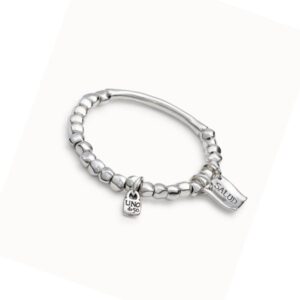 Beaded stretch bracelet with tubular piece and charms